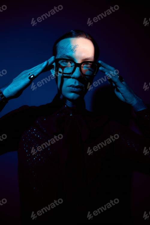 Preview: Captivating young man showcasing unique style in dramatic lighting setting