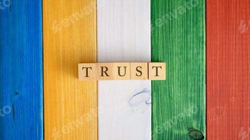 Preview: Top view of the word Trust spelled on wooden cubes