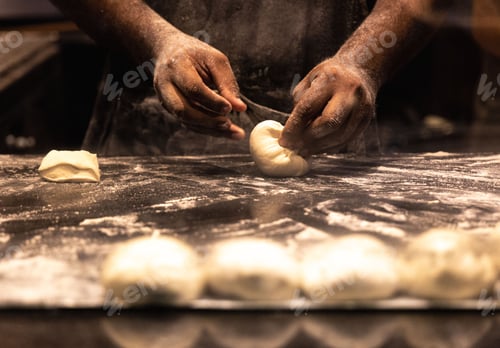 Preview: Professional chef preparing fresh dough on a cutting board in a kitchen in Queensland, Australia