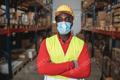 Preview: Portrait of african worker man inside warehouse while wearing safety mask - Focus on man eyes