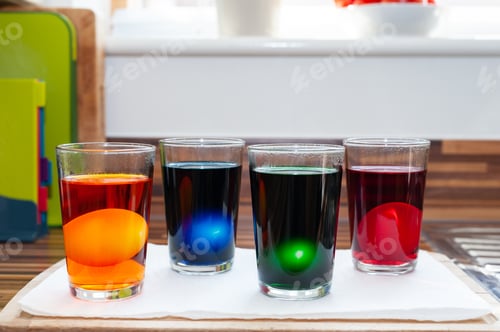 Preview: Variety of artificial neon colored brew in glasses for coloring Ester eggs.