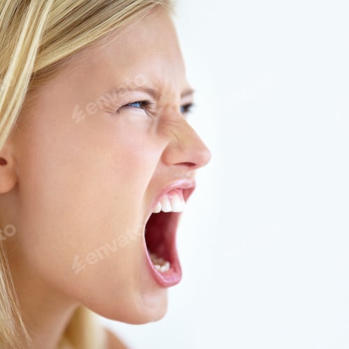 Preview: Letting her voice be heard. Closeup profile of a pretty young blonde screaming alongside copyspace.