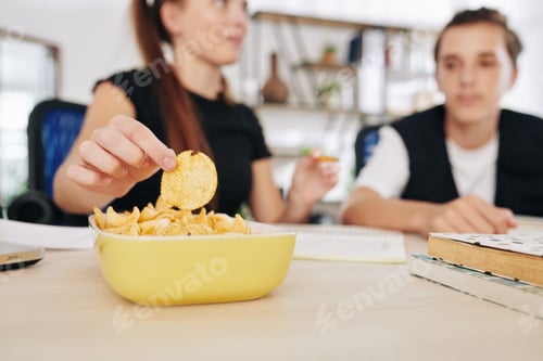 Preview: Friends doing homework and eating chips