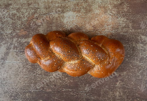 Preview: A loaf of bread on wooden table from top view