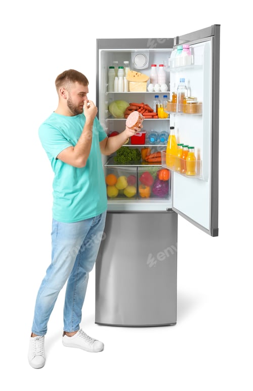 Preview: Young man with expired sausage near open refrigerator on white background