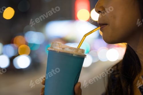 Preview: Woman drink with paper cup at outdoor