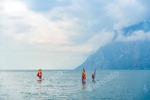 Preview: Athletes practice windsurfing at a surf academy near the lake.