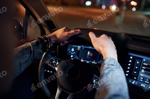 Preview: Handsome unshaved man in fashionable clothes riding his automobile