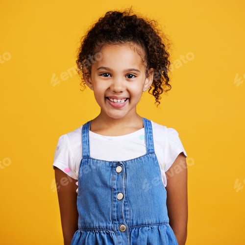 Preview: Studio portrait mixed race girl looking standing alone isolated against a yellow background. Cute h