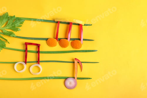 Preview: Musical notes made of vegetables and fruits on color background, top view. Space for text
