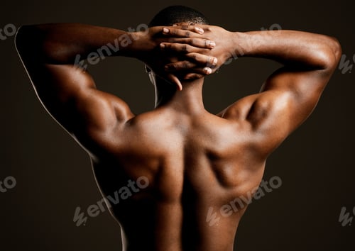 Preview: Rearview studio shot of a fit young man posing against a black background