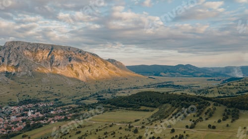 Preview: Sun setting over idyllic village with mountains. Meadow. Panoramic view of Rimetea,