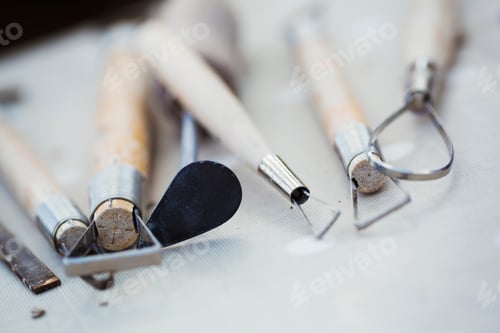 Preview: A row of hand tools for potters on a workbench. Wire shaping tools.