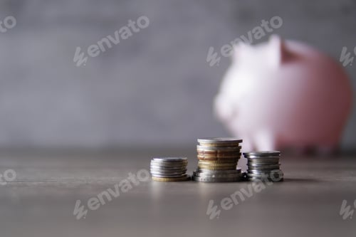 Preview: Selective focus image of coins and piggy bank with copy space for text.