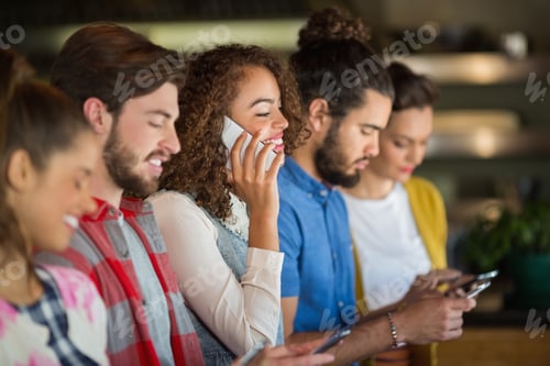 Preview: Young friends using mobile phones