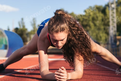 Preview: A female athlete warming up before running.