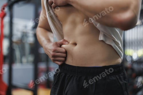 Preview: Athlete checking body fat in gym after workout session