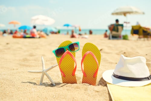 Preview: Starfish near flip flops and sunglasses on beach