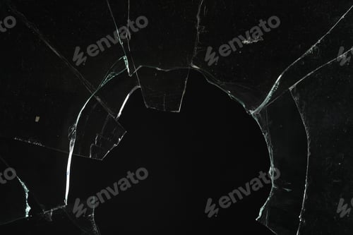 Preview: Closeup view of broken glass with cracks on black background