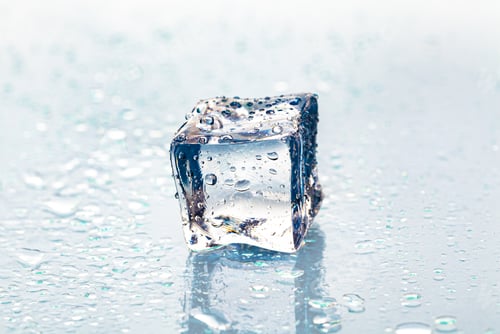Preview: Square melting ice cubes on wet table