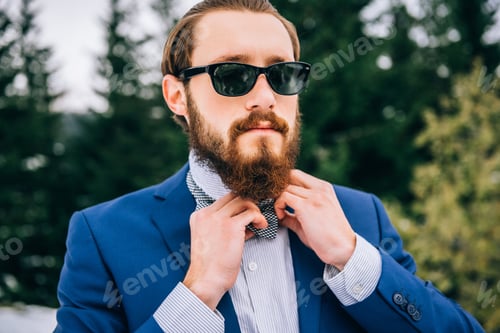Preview: groom in a blue suit in the mountains Carpathians
