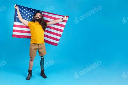 Preview: Proud man with prosthetic leg raising a north american flag