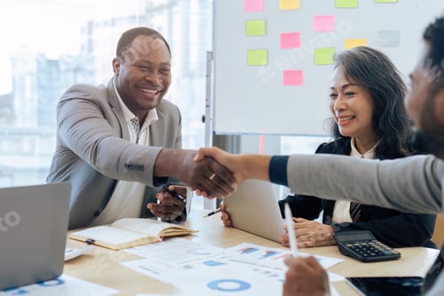 Preview: Handshake of businessman and a partner after success of planning strategy marketing in the office