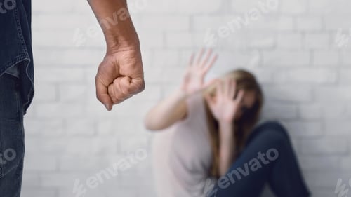 Preview: Man clenches fist about to beat woman, scared wife sits on floor, closes her face