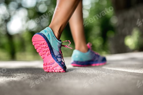 Preview: Woman fitness sunrise jog workout welness concept. Runner feet running on road closeup on shoe.
