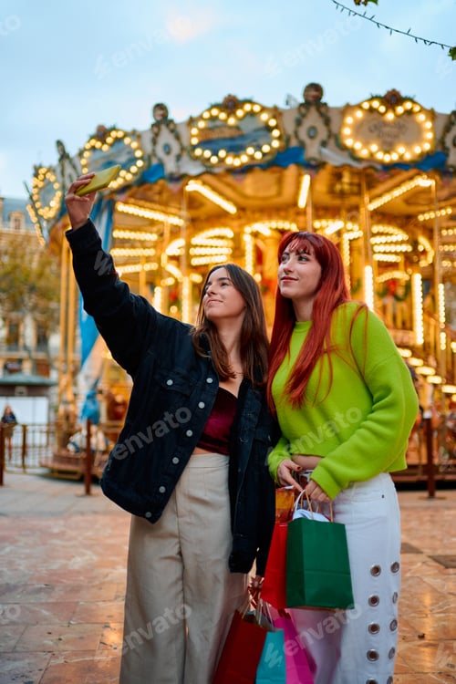 Preview: Friends taking selfie outside carousel after shopping trip