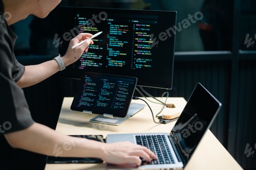 Preview: Male programmer using stylus to analyze code on tablet and monitor. Software development, coding,