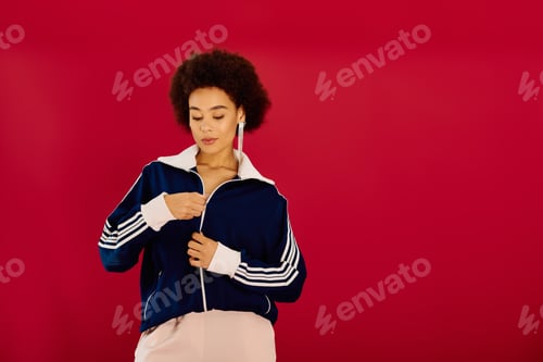 Preview: A young woman shows emotions in a stylish track jacket against a vibrant WC KP I VETUSHKO backdrop