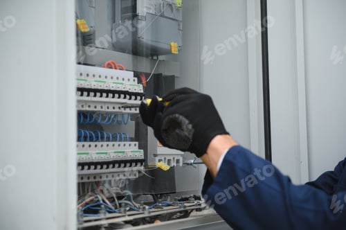 Preview: Electricians work to connect electric wires in the system, switchboard