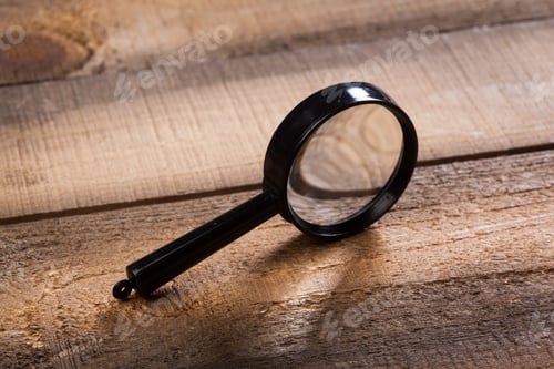 Preview: magnifying glass on the wooden background