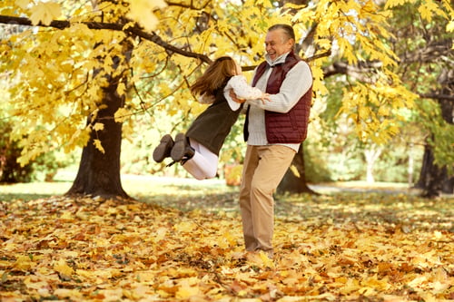 Preview: Senior man with her granddaughter have fun at the park in autumn