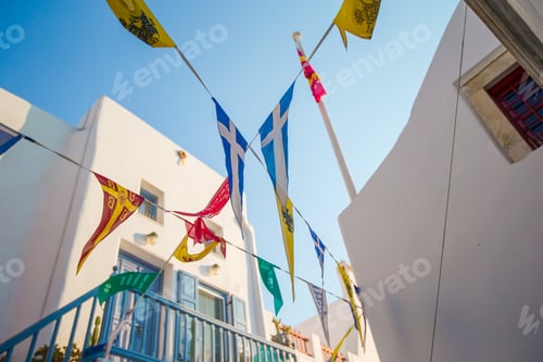 Preview: Festive Flags Hanging Above a White Building