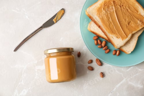 Preview: Flat lay composition with peanut butter and toasts on grey background