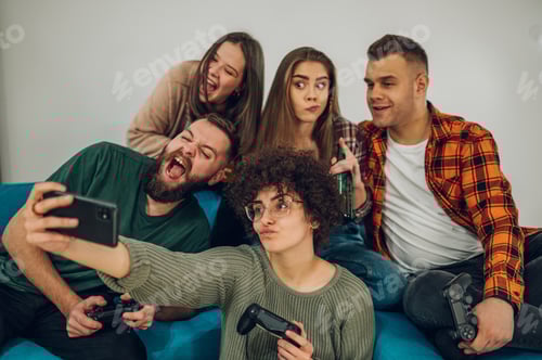 Preview: Friends having fun at home and taking selfie with a smartphone
