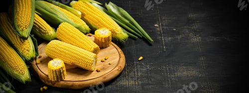 Preview: Fresh corn on cutting board.