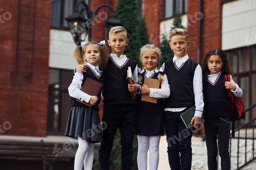 Preview: Group of kids in school uniform that is outdoors together near education building
