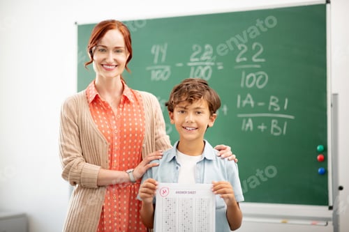 Preview: Red-haired teacher smiling and hugging her clever pupil