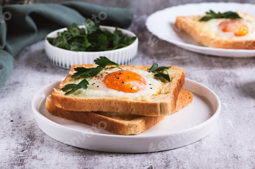Preview: An egg baked in pieces of bread on a plate on the table