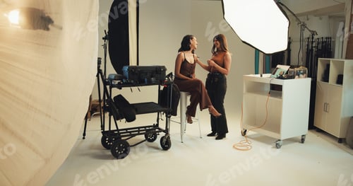 Preview: Woman, model and photographer discussion in studio for photoshoot, photography and production. Behi