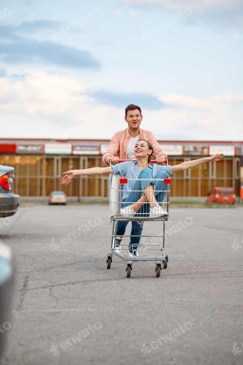 Preview: Funny family couple rides in cart on parking