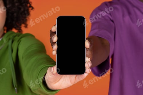 Preview: Unrecognizable multiracial couple holding phone with blank screen