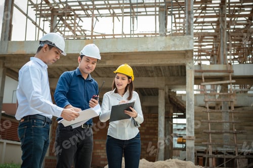 Preview: Construction manager and engineer working on building site.