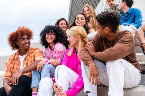 Preview: Happy playful multiethnic group of young friends bonding outdoors