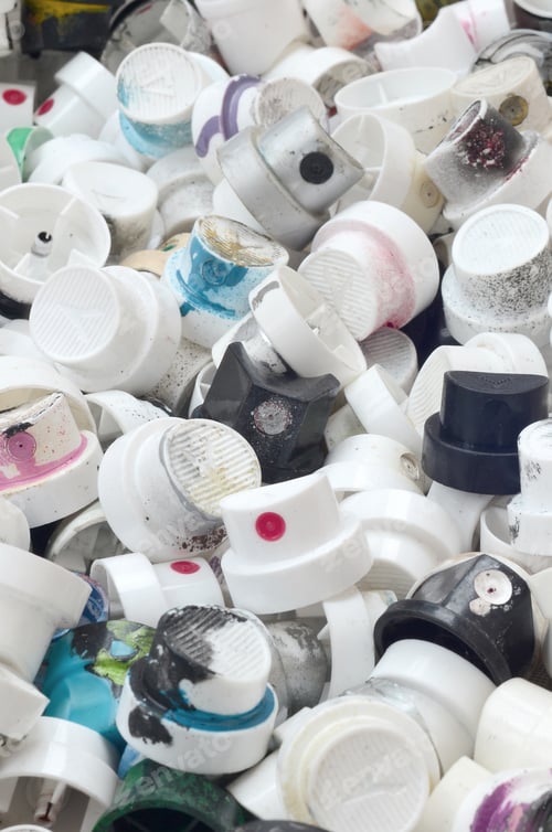 Preview: A pattern of many used and soiled nozzles from spray cans with aerosol paint