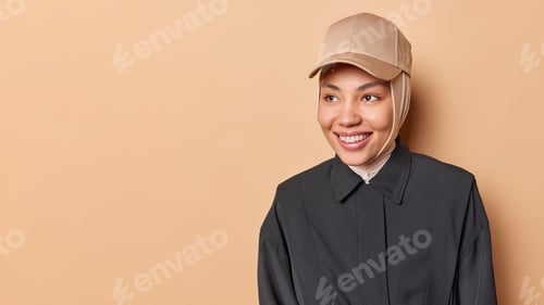 Preview: Portrait of emotive good-looking caucasian woman laughing while looking aside and standing against