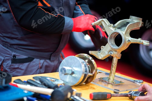 Preview: a car mechanic works in a car repair shop, close-up of hand
